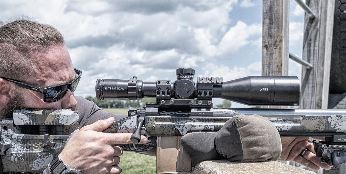 Man looking through and Elite Tactical  riflescope