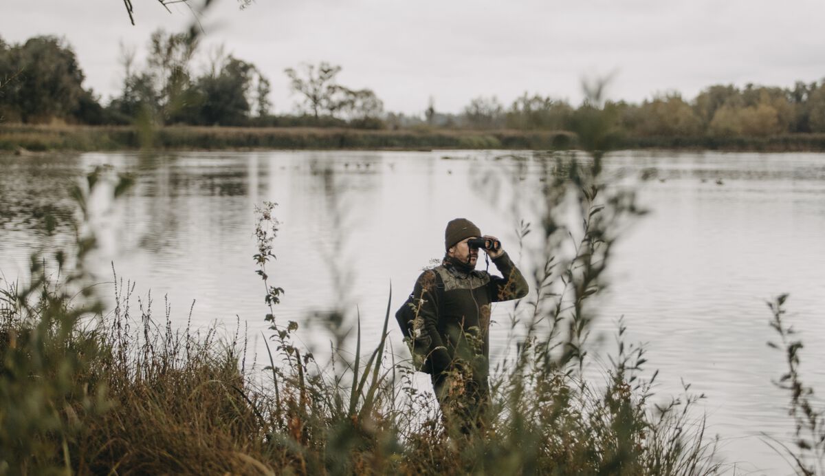 man looking through binoculars - on the hunt for a deal